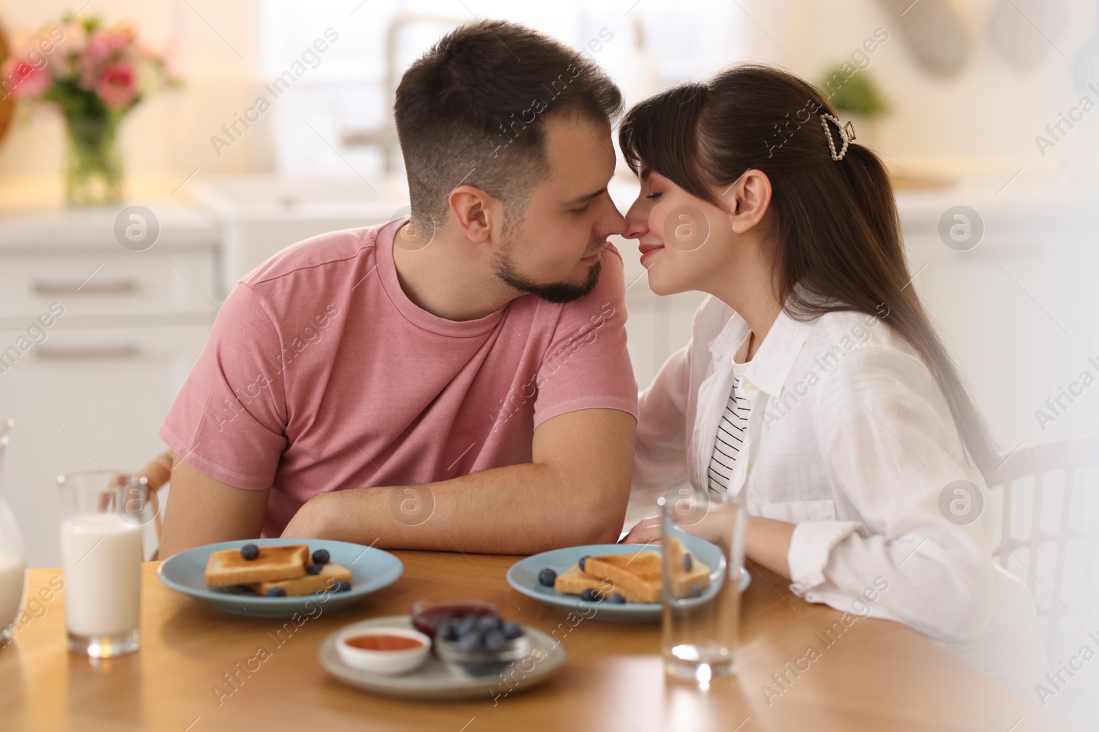 Photo of Lovely couple spending time together during breakfast at home