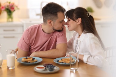 Lovely couple spending time together during breakfast at home