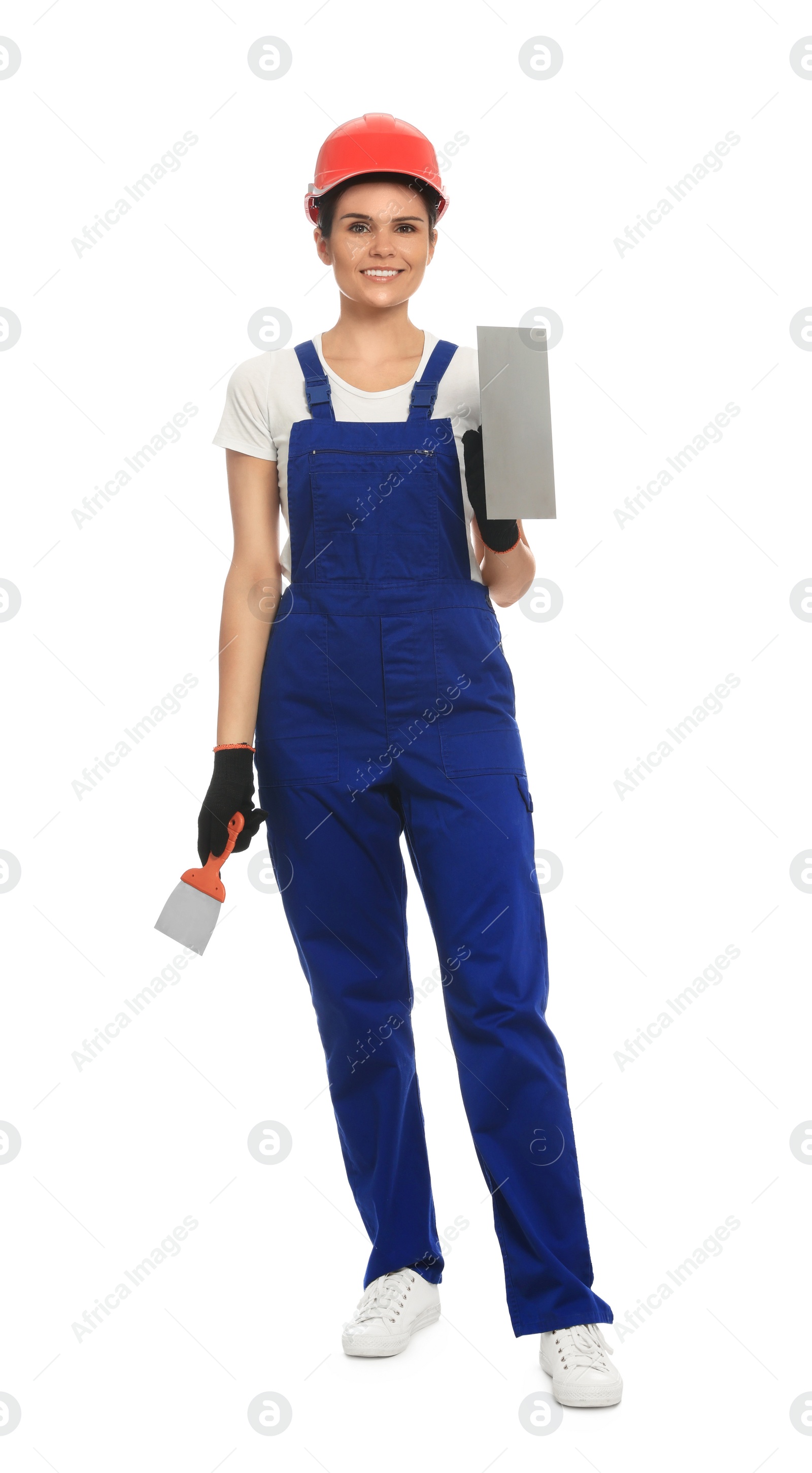 Photo of Professional worker with putty knives in hard hat on white background