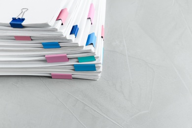 Photo of Stack of documents with binder clips on light table