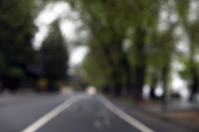 Photo of Blurred view of park on grey day. Bokeh effect