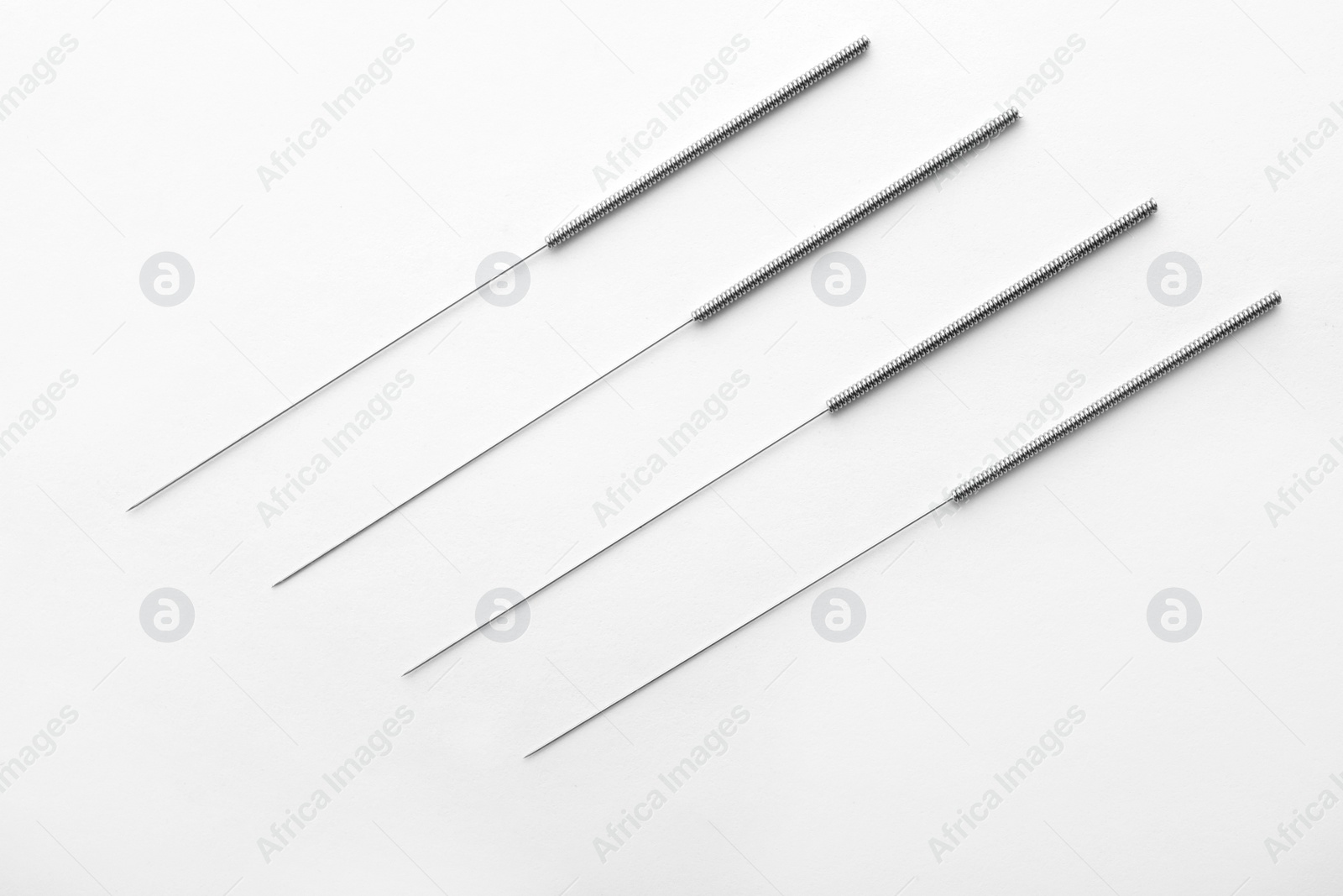 Photo of Needles for acupuncture on white background