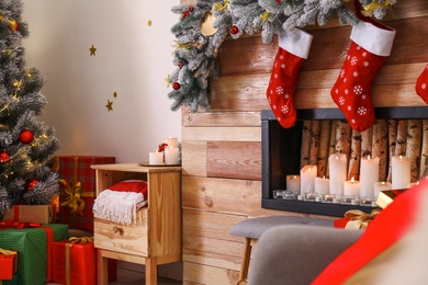 Stylish room interior with decorative fireplace. Christmas time