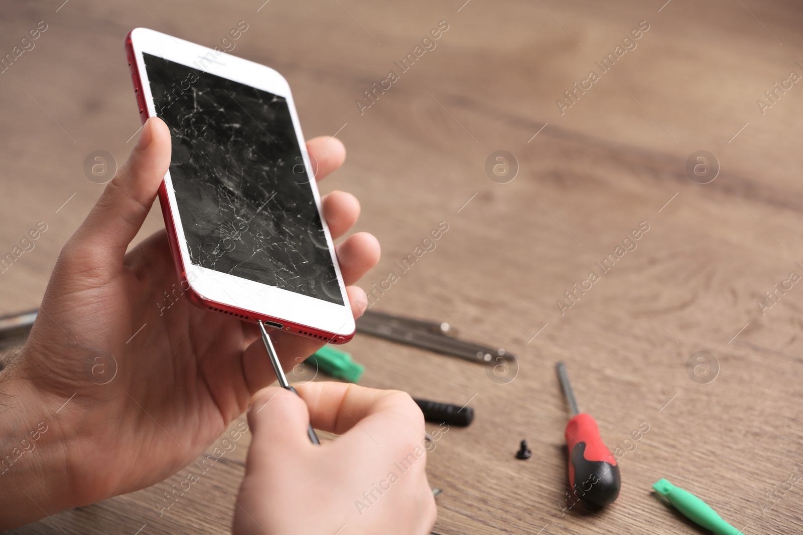 Photo of Technician fixing mobile phone at table, closeup. Device repair service