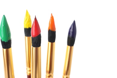 Photo of Brushes with colorful paints on white background