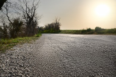 Asphalt road in countryside on sunny day, ground level view