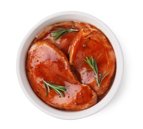 Raw marinated meat and rosemary in bowl isolated on white, top view