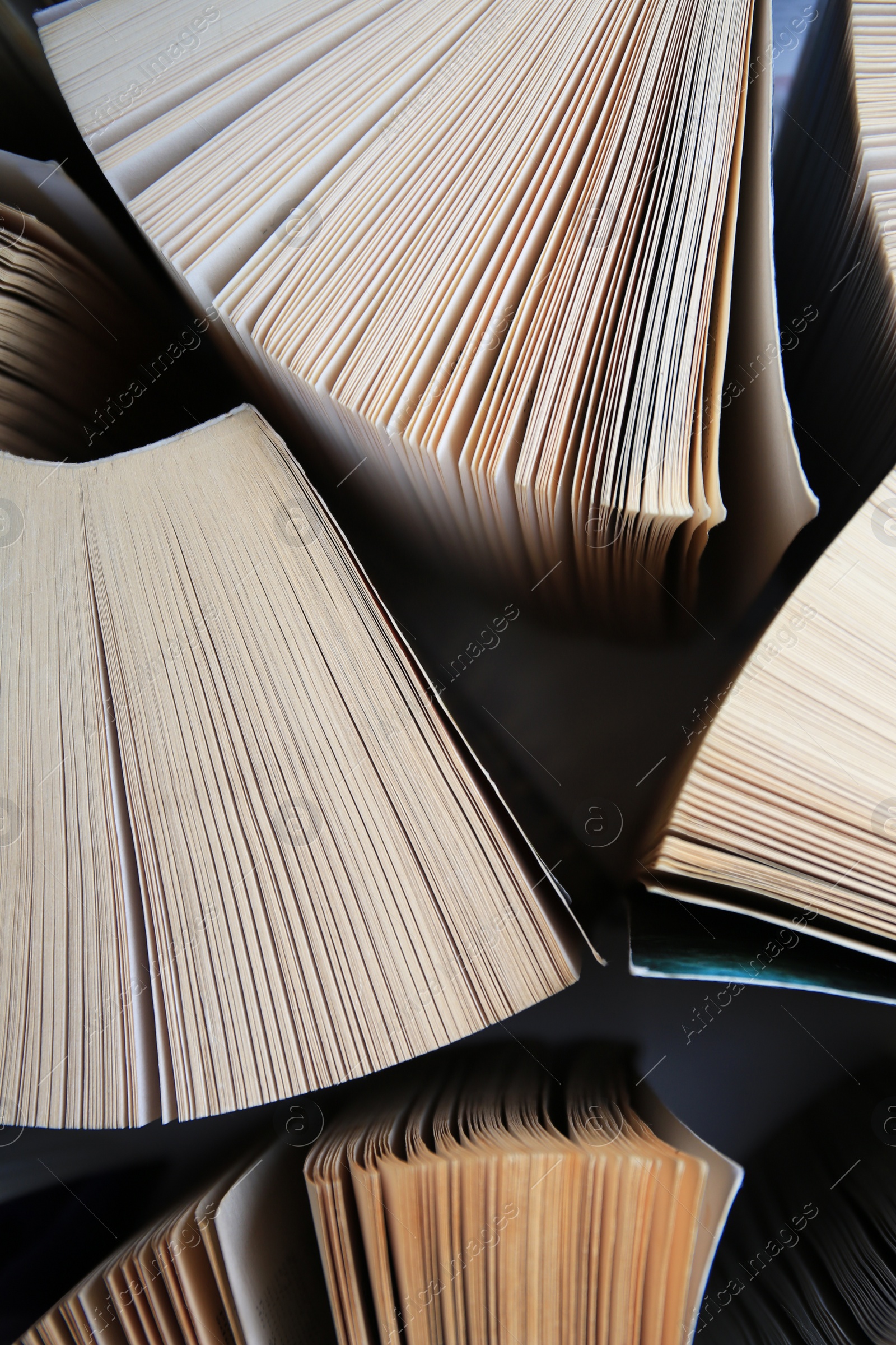 Photo of Collection of different books on white shelf, above view