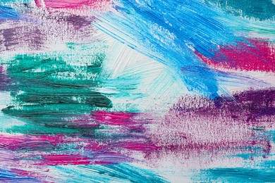 Photo of Strokes of colorful acrylic paints on white canvas, closeup