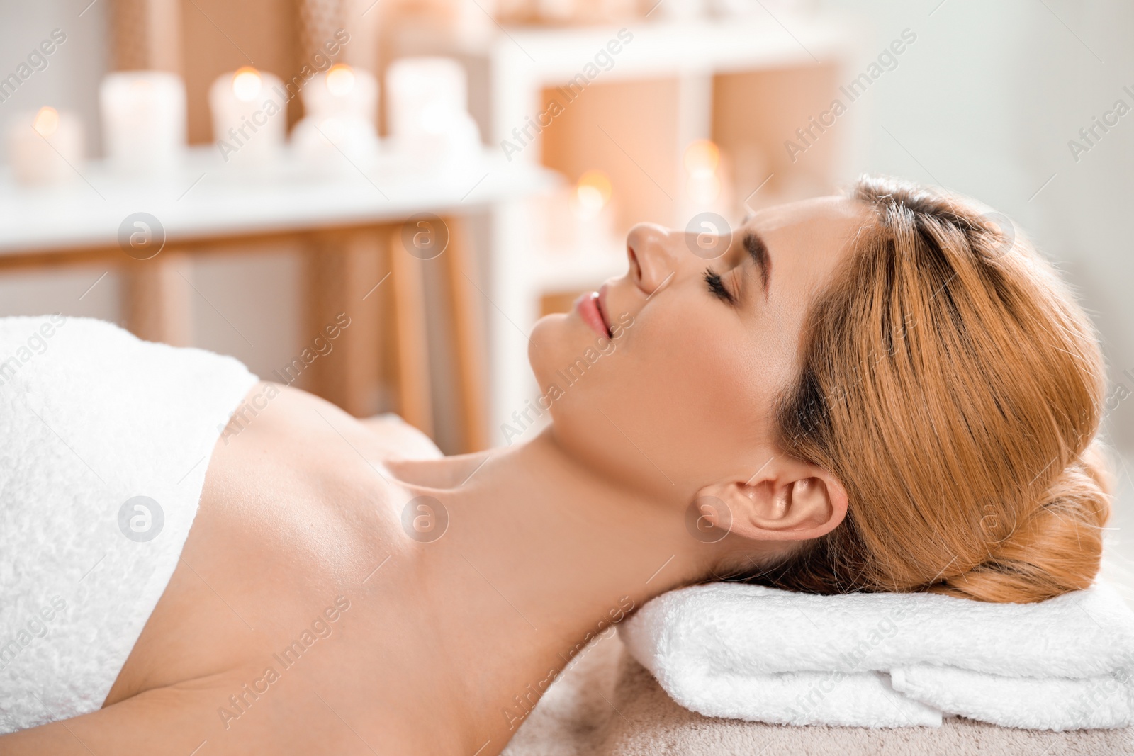 Photo of Beautiful woman with silky skin after face mask relaxing in spa salon