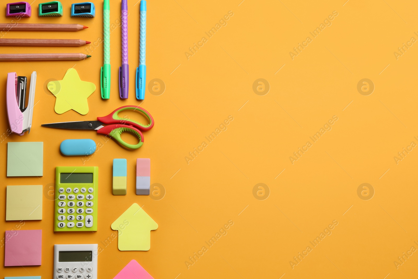 Photo of School stationery on orange background, flat lay with space for text. Back to school