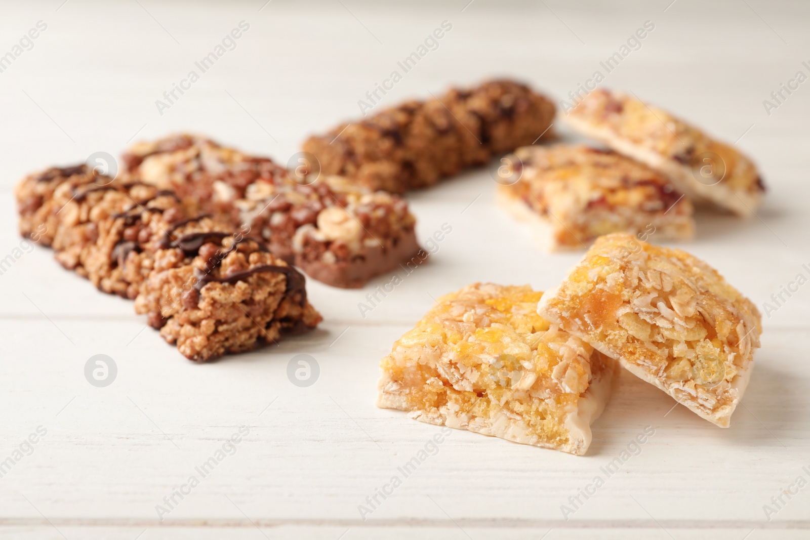 Photo of Tasty protein bars on white table. Healthy snack