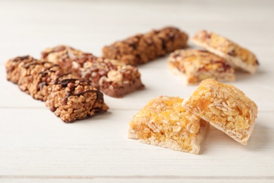 Photo of Tasty protein bars on white table. Healthy snack