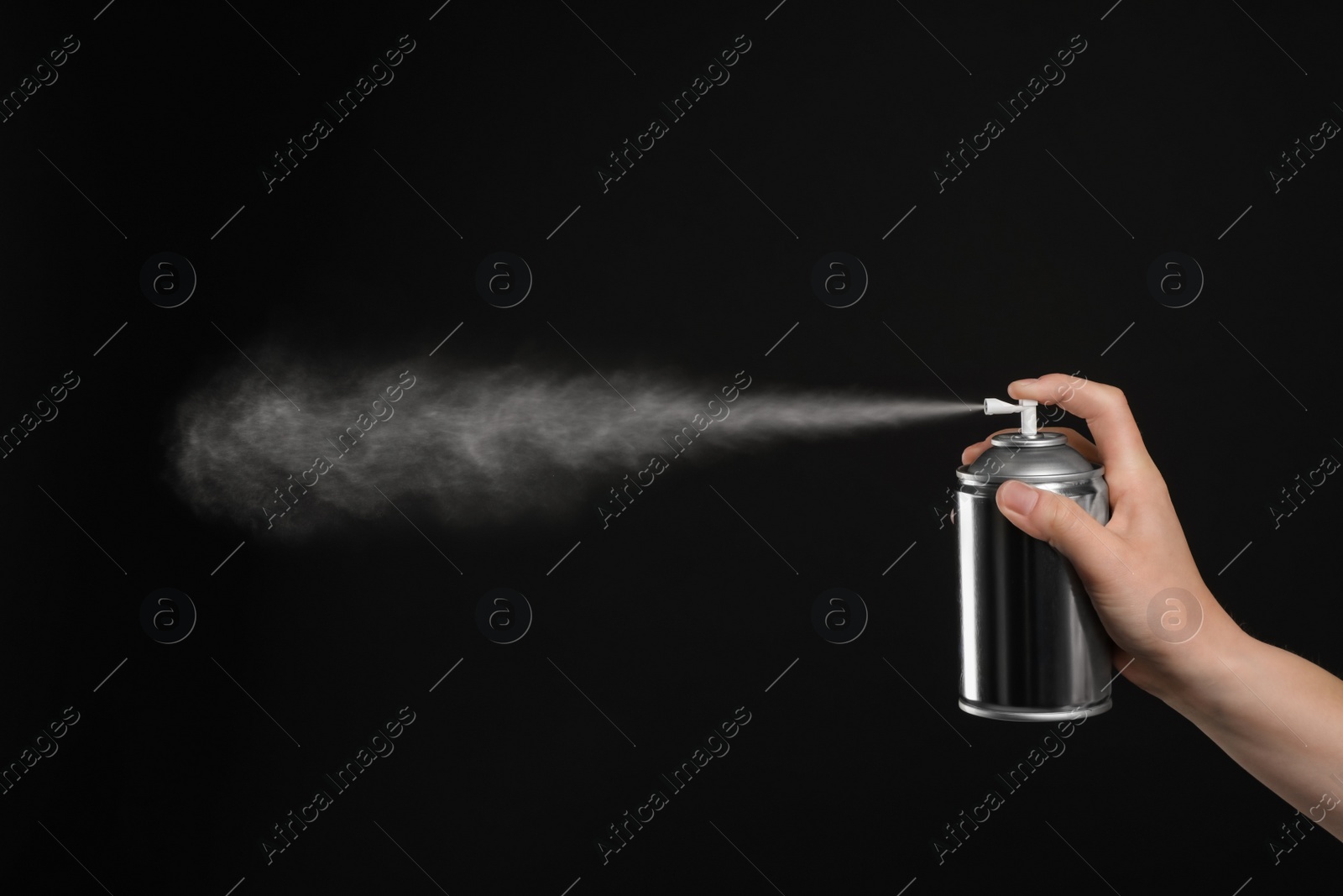 Photo of Woman spraying air freshener on black background, closeup