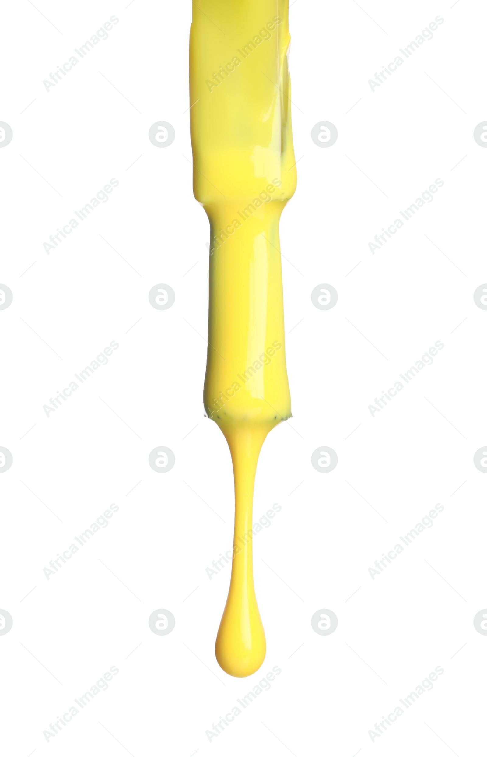 Photo of Yellow nail polish dripping from brush isolated on white