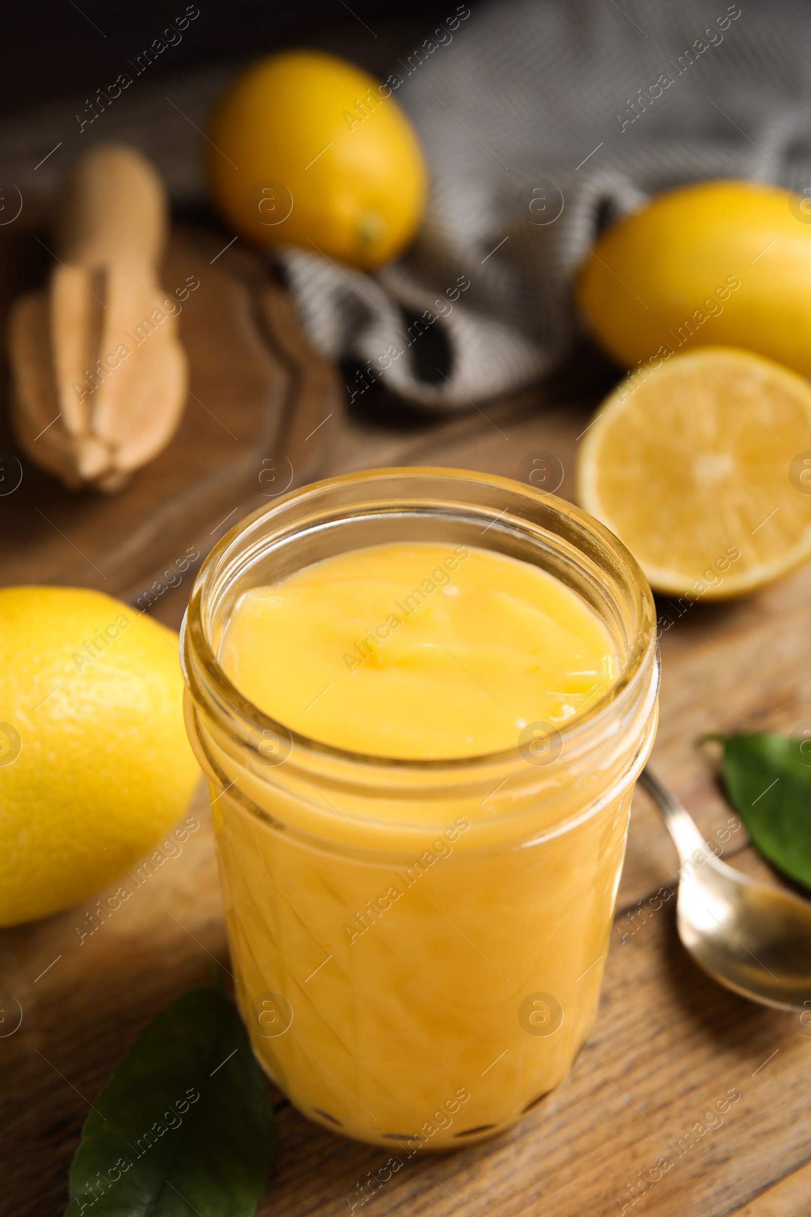 Photo of Delicious lemon curd and fresh fruits on wooden table