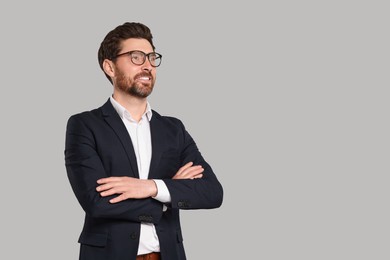 Photo of Happy real estate agent in glasses on grey background. Space for text
