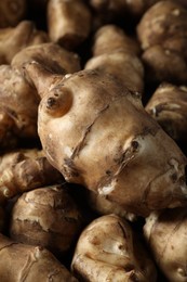 Many fresh Jerusalem artichokes as background, closeup