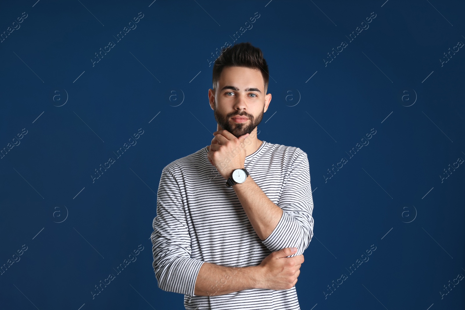 Photo of Portrait of handsome young man on color background