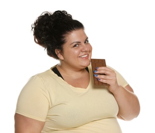 Photo of Happy overweight woman with chocolate on white background