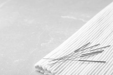 Acupuncture needles on towel, closeup. Alternative medicine