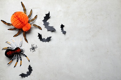 Halloween decor elements on light grey background, flat lay. Space for text