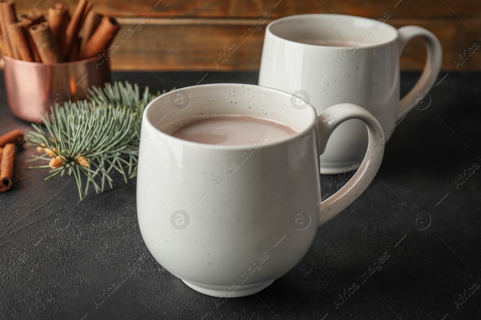 Photo of Cups with delicious hot cocoa drink on table