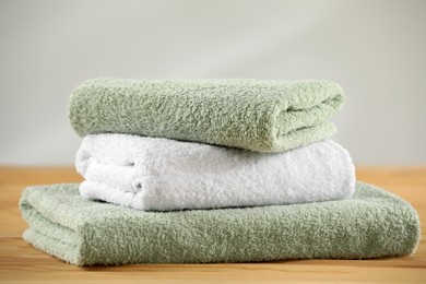 Stack of folded towels on wooden table