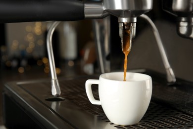 Photo of Making fresh aromatic espresso using professional coffee machine