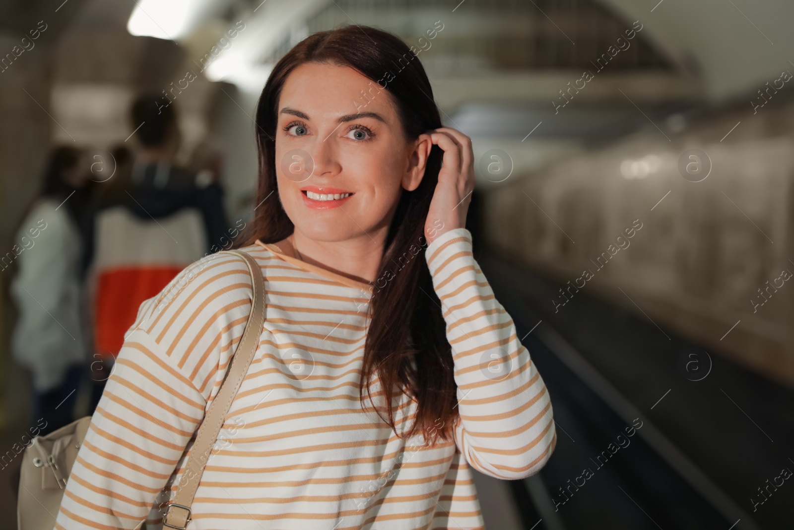 Photo of Beautiful woman on subway station. Public transport