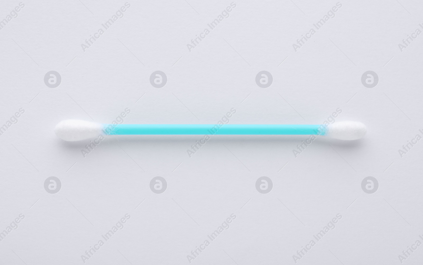 Photo of Clean cotton bud isolated on white, top view. Hygienic accessory