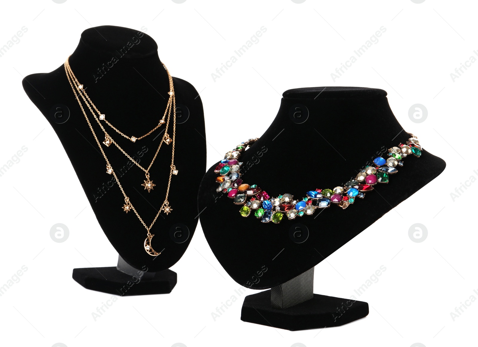 Photo of Stylish necklaces on jewelry busts against white background