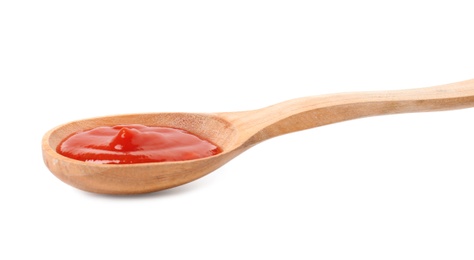 Photo of Wooden spoon with red sauce on white background
