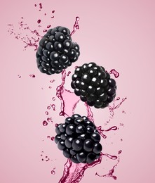 Image of Fresh blackberries and juice in air on pink background