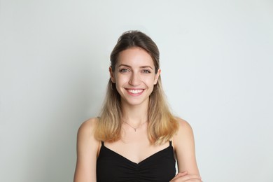 Photo of Portrait of beautiful woman on light background