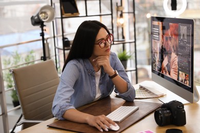 Professional retoucher working on computer in office