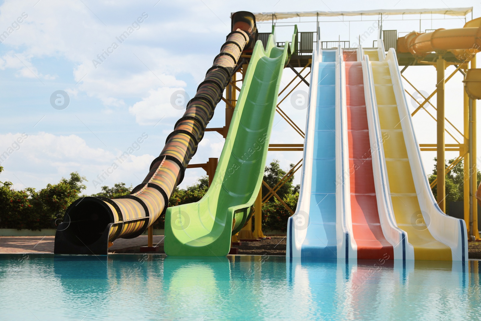 Photo of Beautiful view of water park with colorful slides and swimming pool on sunny day