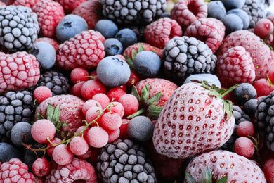 Mix of different frozen tasty berries as background, closeup