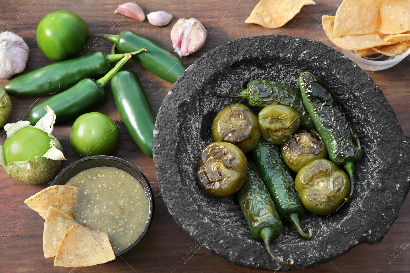 Photo of Different ingredients for cooking tasty salsa sauce on wooden table, above view