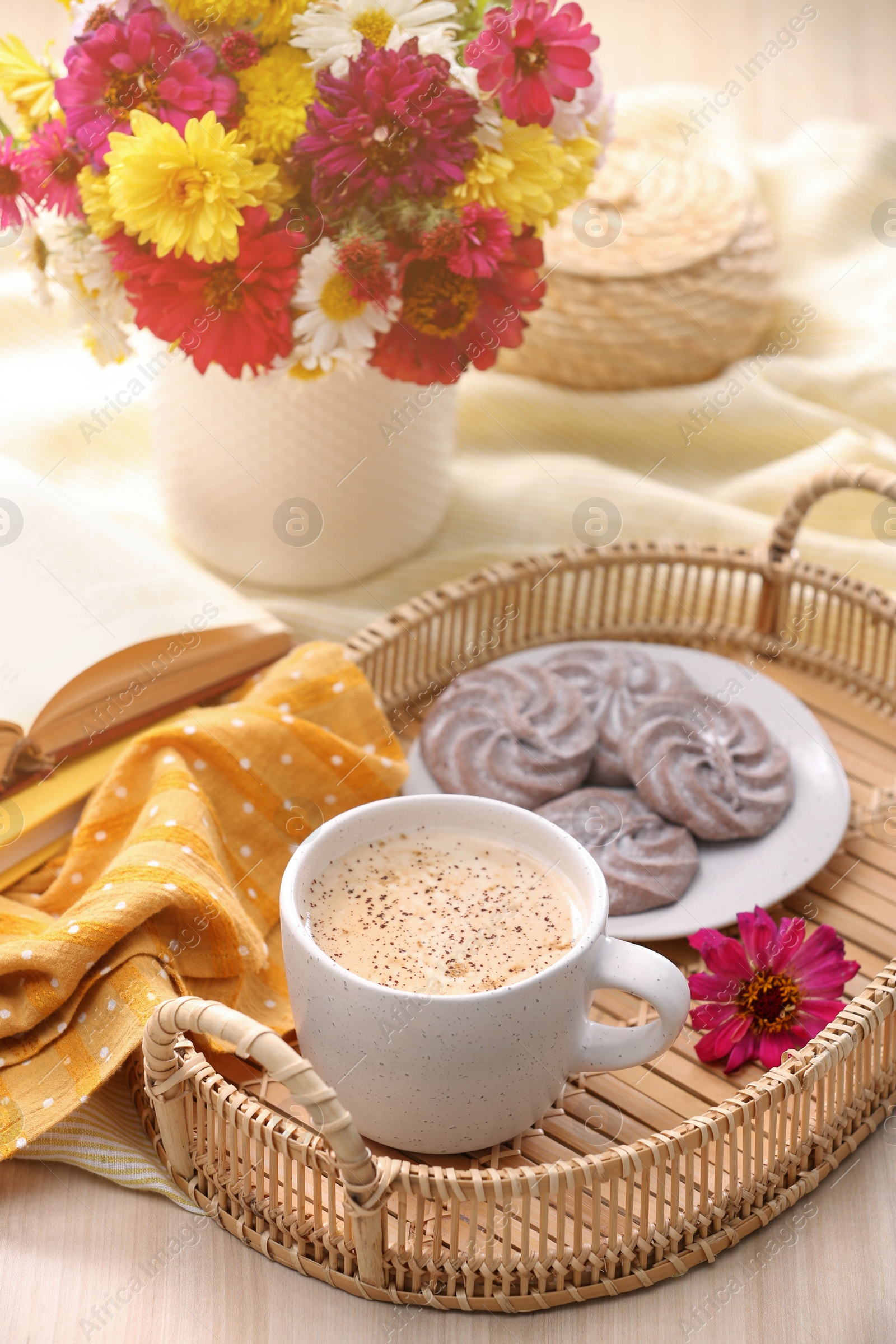 Photo of Cup of hot coffee, delicious cookies and beautiful bouquet on wooden table