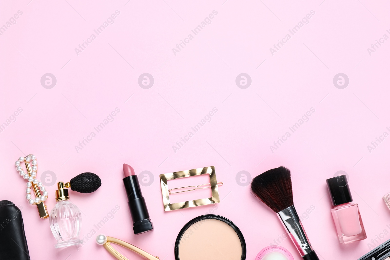 Photo of Makeup brushes and cosmetic products on pink background, flat lay. Space for text