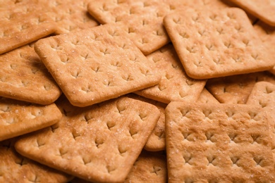 Photo of Many delicious crackers as background, closeup view
