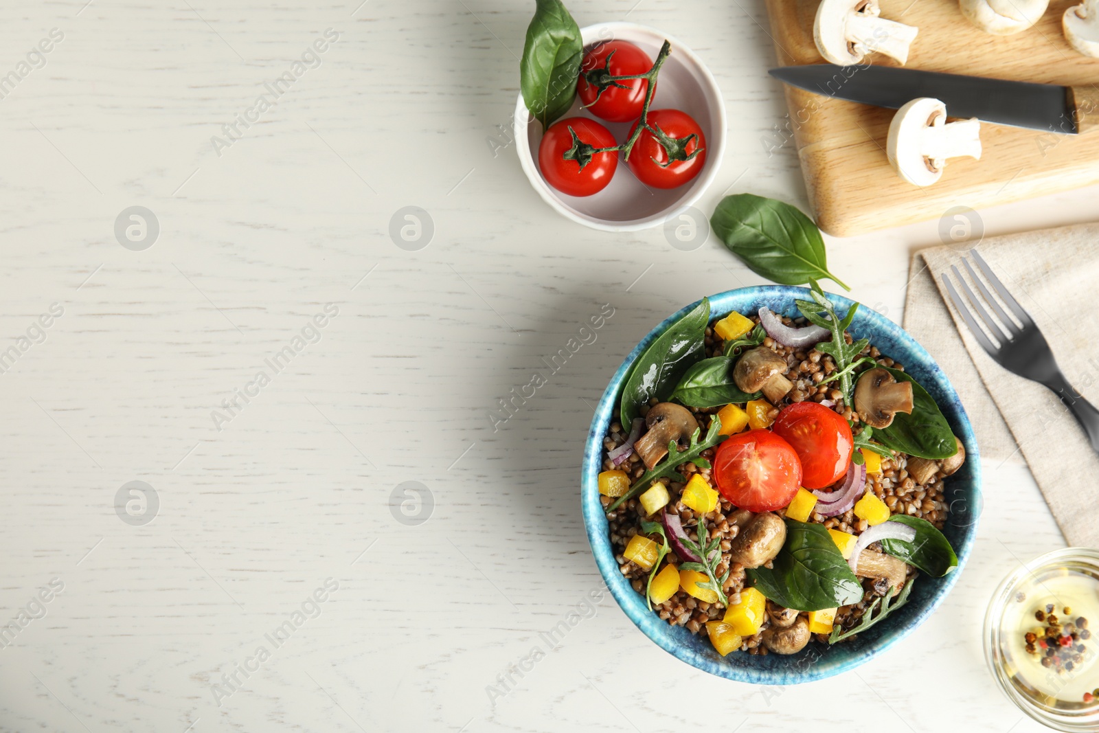 Photo of Flat lay composition with tasty buckwheat porridge on white wooden table, space for text