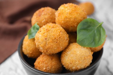 Photo of Delicious fried tofu balls with basil in bowl, closeup