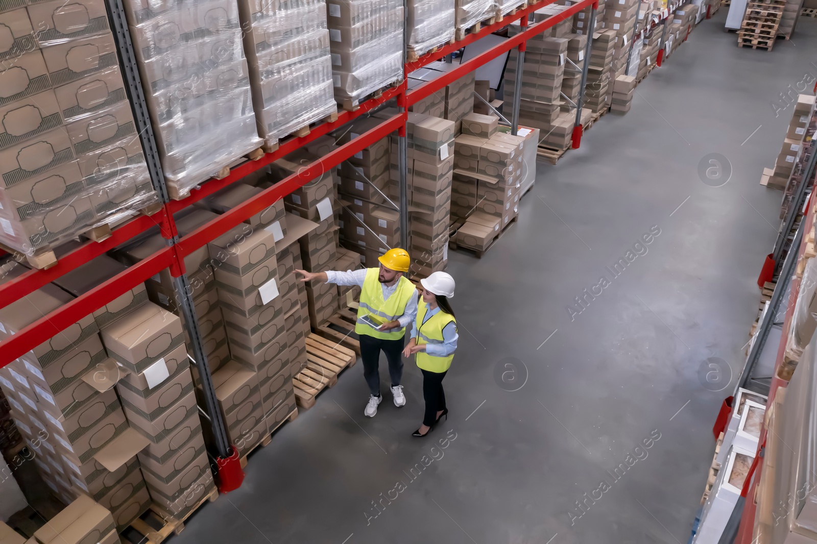 Image of Manager and worker at warehouse, above view. Logistics center