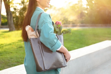 Woman with leather shopper bag in park, closeup