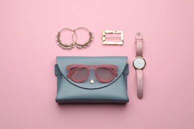 Photo of Stylish woman's bag and accessories on pink background, flat lay
