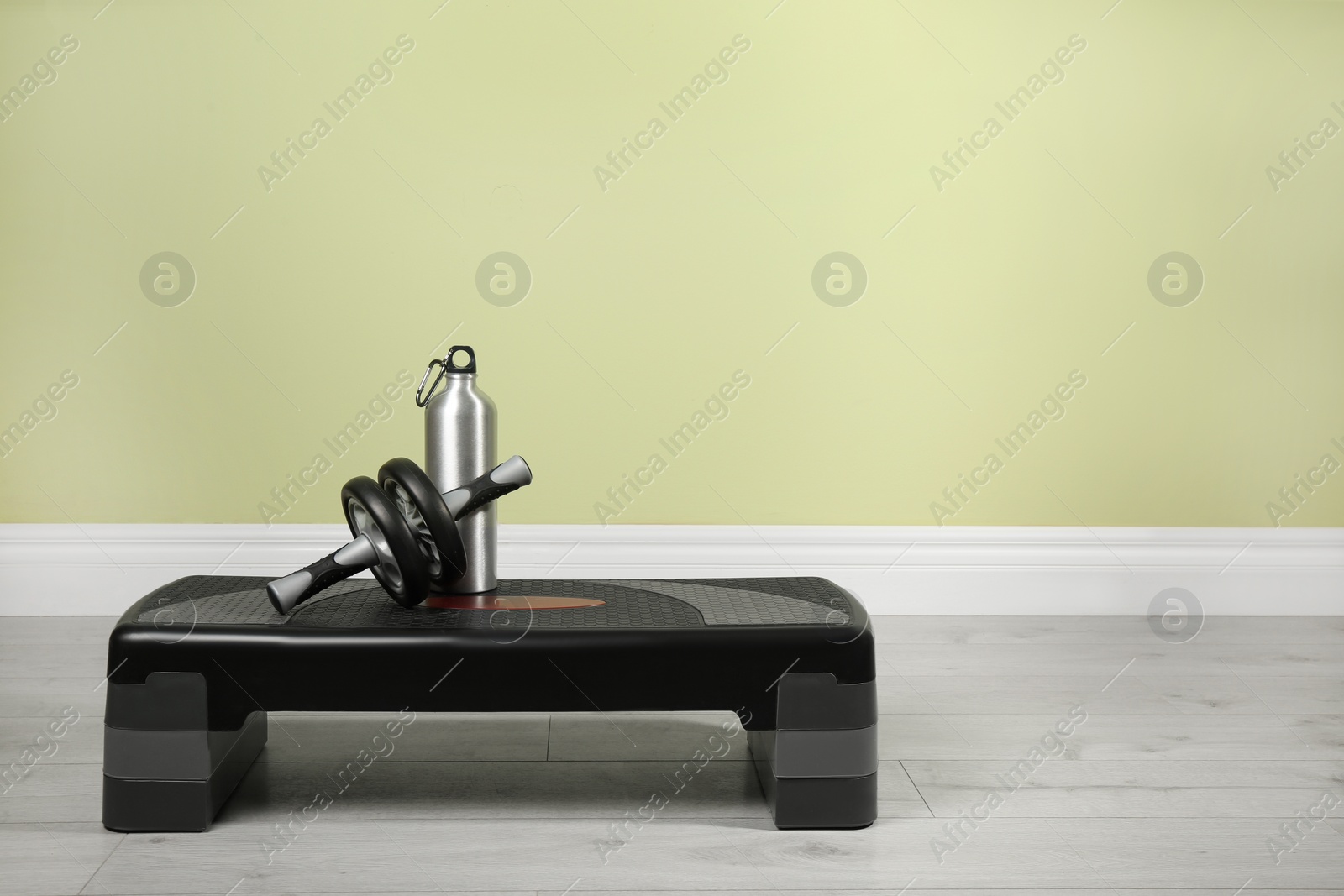 Photo of Step platform and sports equipment indoors. Space for text