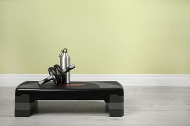 Photo of Step platform and sports equipment indoors. Space for text