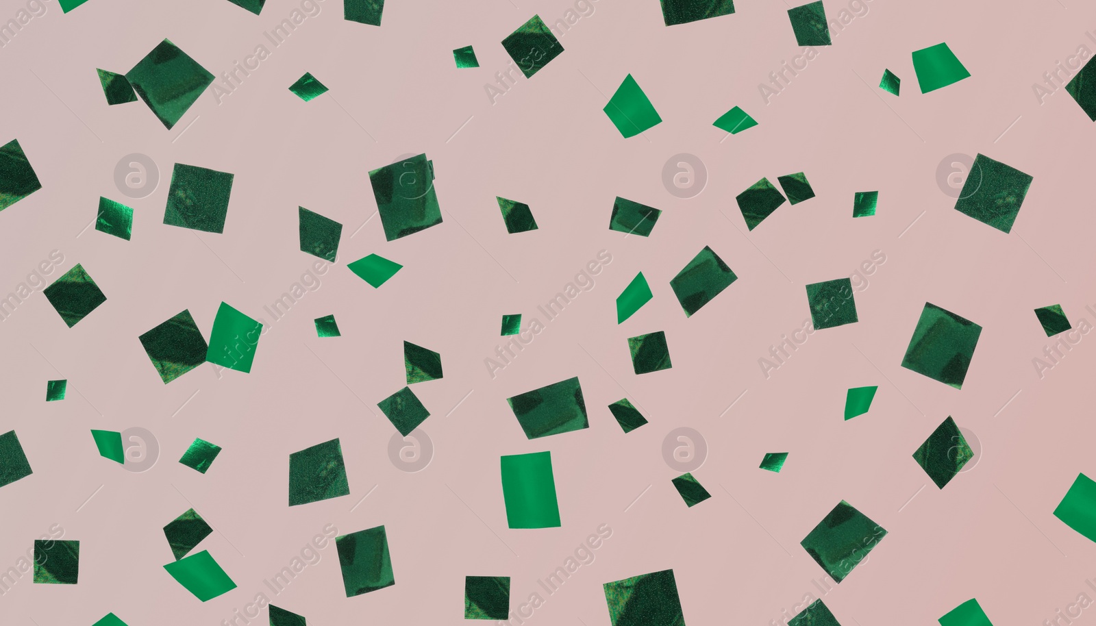 Image of Shiny green confetti falling on dark beige background. Banner design